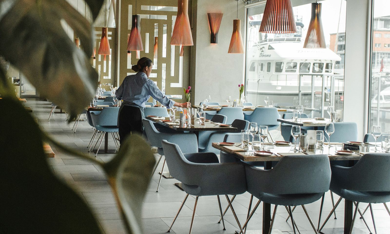 Hotel restaurant staff setting a table