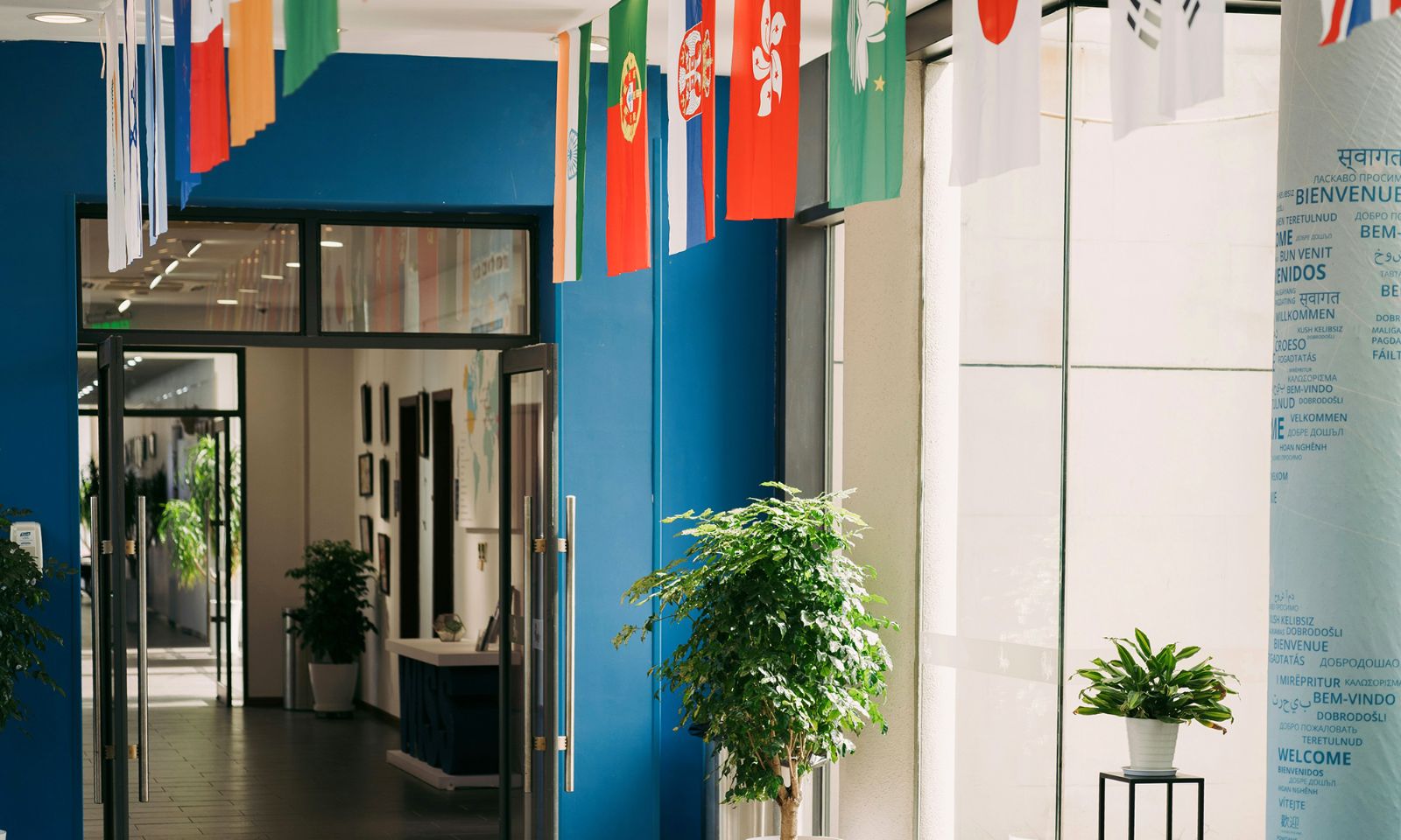 School corridor with flags of many countries and multilingual welcome signs
